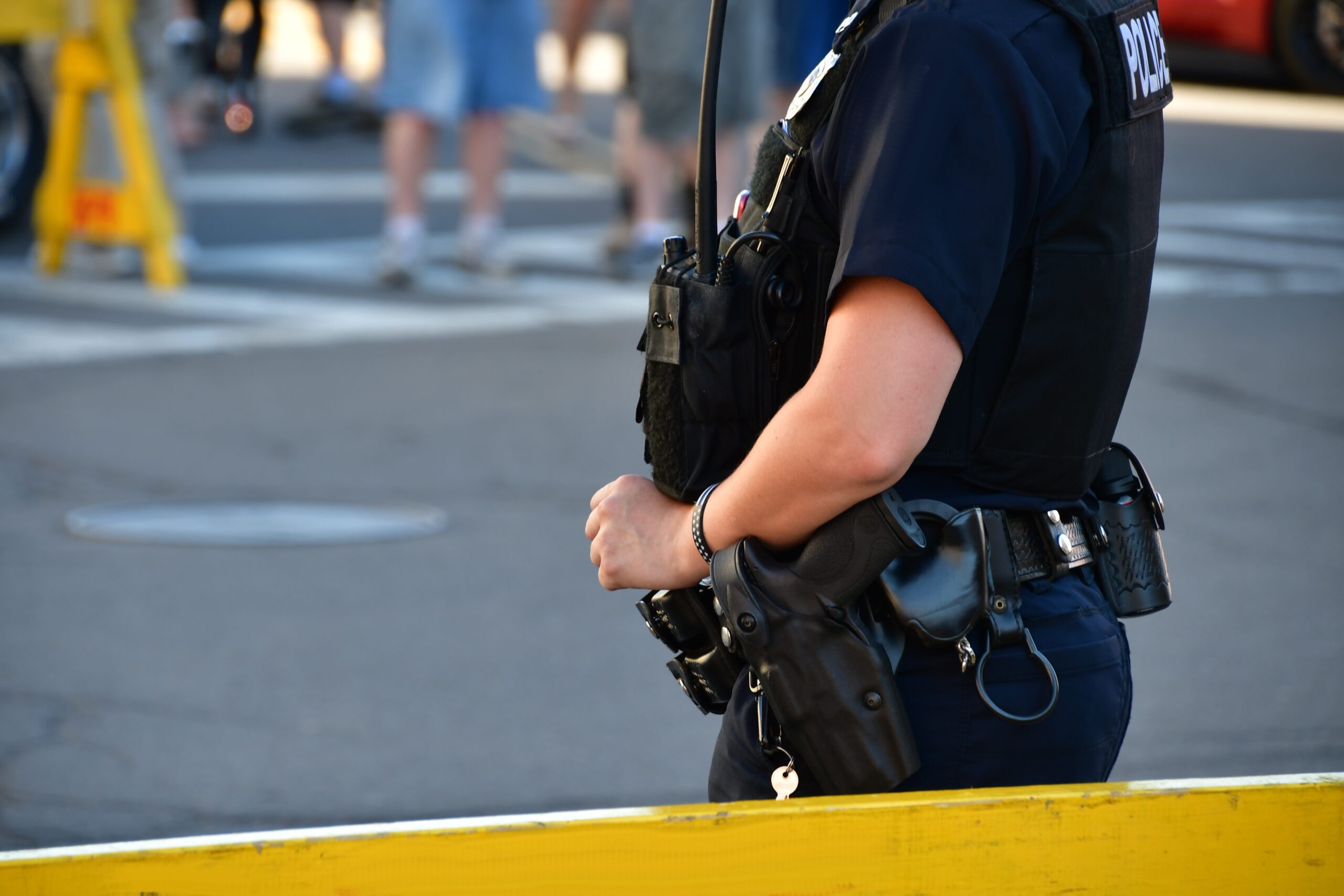 female-police-officer-standing-guard-behind-a-barr-2022-11-14-04-15-48-utc